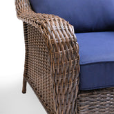 Close-up view of the armrest on the Cambridge sectional, showcasing the detailed wicker weave and plush, weather-resistant cushion.